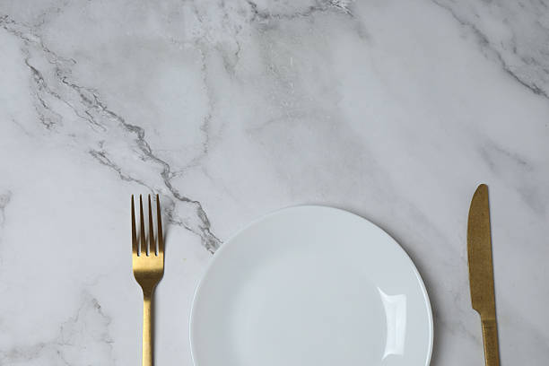 istock Empty plate and cutlery on colored background, top view 2253898784