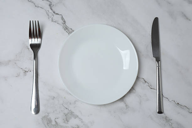 istock Empty plate and cutlery on colored background, top view 2253898790