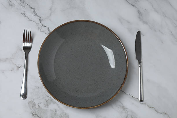 istock Empty plate and cutlery on colored background, top view 2253898792