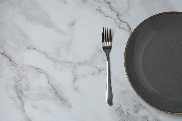 istock Empty plate and cutlery on colored background, top view 2253898794