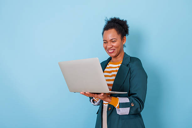 istock Happy black woman working remotely using laptop computer, smiling for online video call or internet browsing 2253903535