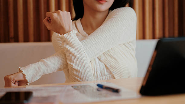 istock Asian woman relieving stiffness with stretches after using a digital tablet 2253904551