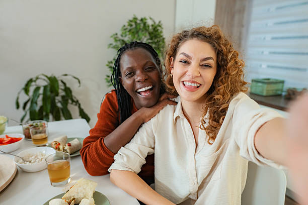 istock Diverse friends taking selfie enjoying lunch at home 2253904715