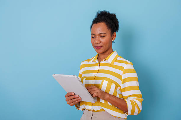 istock Black woman using digital tablet, browsing online content, connecting with technology and the internet 2253904911