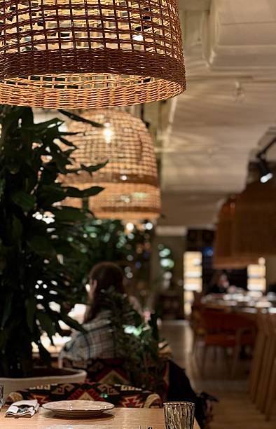 Vibrant Restaurant Ambiance, Cozy Evening Dining Environment, Warm Lighting Enhances Lively Dining Experience, Intimate Restaurant Scene With Inviting Glow And Busy Staff