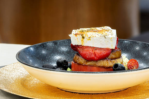 Feta cheese, Tomato, pepper and Eggplant Tower stack, healthy snack served on the plate