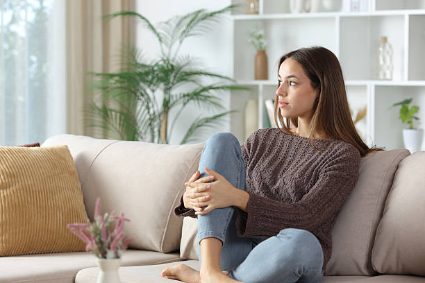 istock Serious woman thinking at home looking away 2253907814