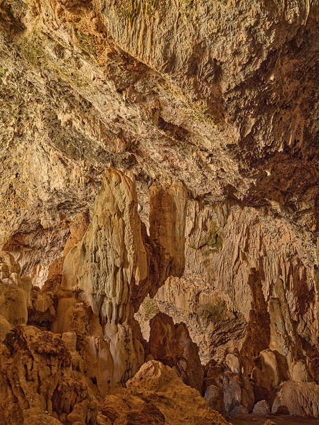 Creteâs underground landscape unfolds in a warm, sunlit cave filled with towering stalactites and weathered limestone textures. This Crete geological scene captures the ancient, natural artistry of Greece, emphasizing rugged formations, quiet atmosphere, and the sense of discovery that caves offer to visitors.