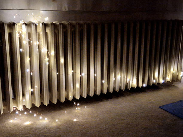 istock classic sectional cast iron radiator decorated with LED string light, called fairy lights. 2253910224