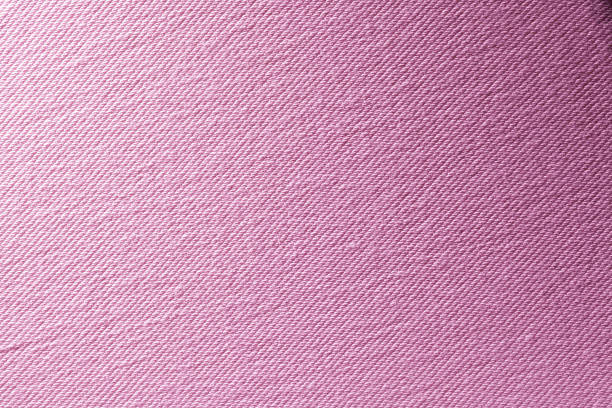Close up of crumpled purple fabric texture with intricate folds, perfect for backgrounds or textile design.