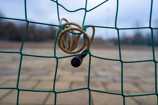 wooden rods are inserted into a board with holes and connected with multi-colored threads. Stock photo