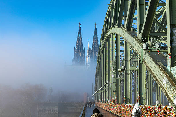 Cologne Cathedral seen in the morning mist over the Hohenzollern Bridge