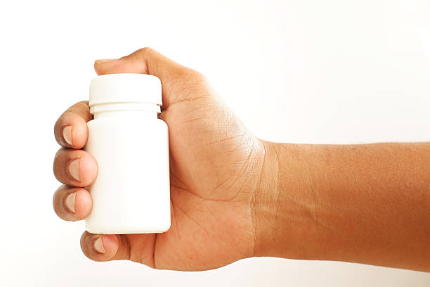 istock Hand Holding White Pill Bottle mockup 2253913619