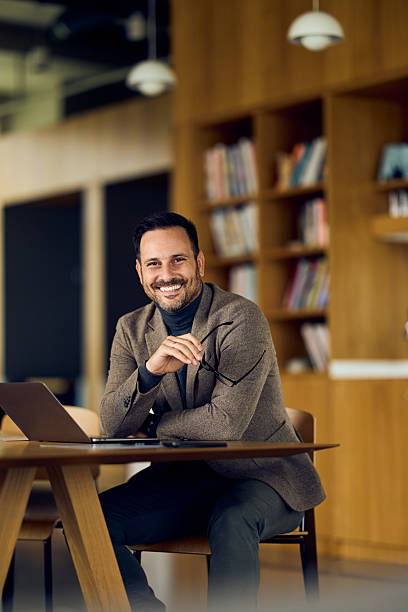 istock Affable Professional Man Smiling At Laptop In Modern Library Space During Workday Break 2253913759