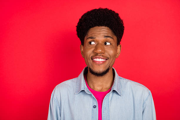 istock Portrait of attractive cheerful curious brunet guy thinking copy empty space isolated over bright red color background 2253914614
