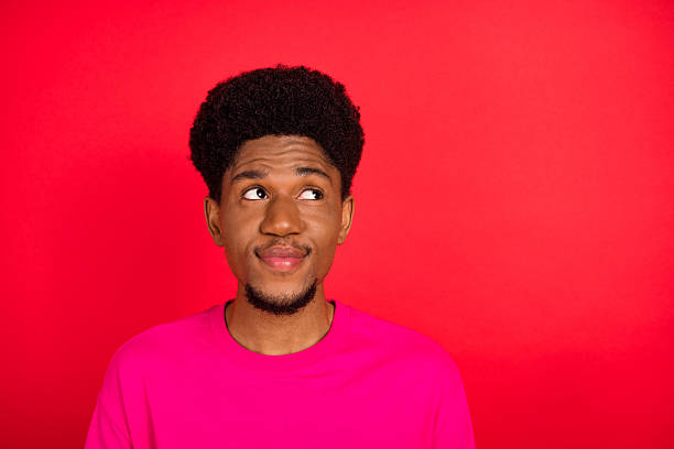istock Portrait of attractive cheerful curious brunet guy thinking copy empty space isolated over bright red color background 2253914615