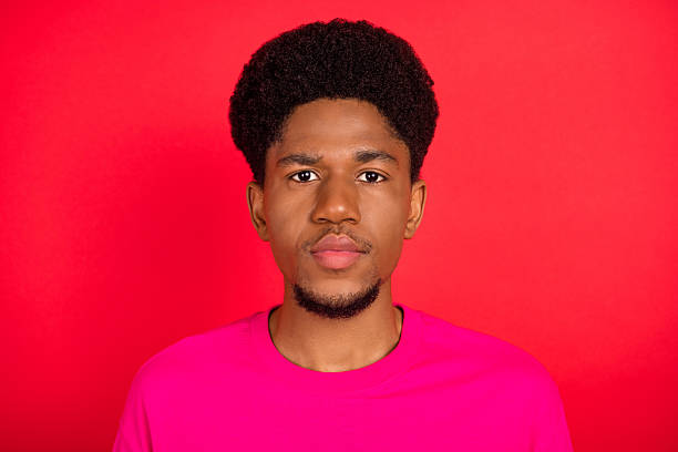 Portrait of attractive cheerful curious brunet guy thinking copy empty space isolated over bright red color background