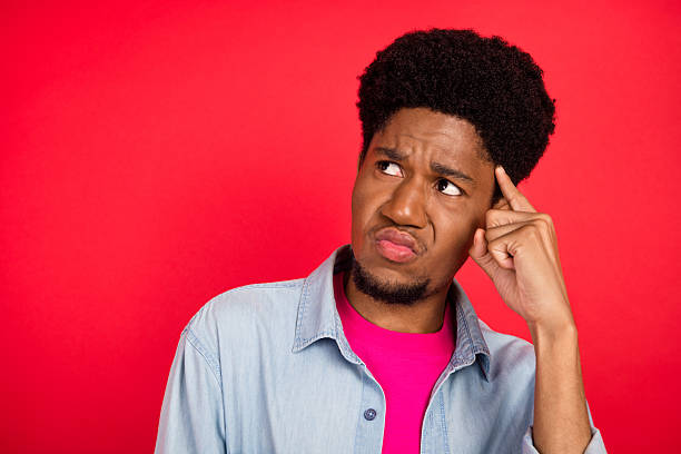 istock Portrait of attractive cheerful curious brunet guy thinking copy empty space isolated over bright red color background 2253914724