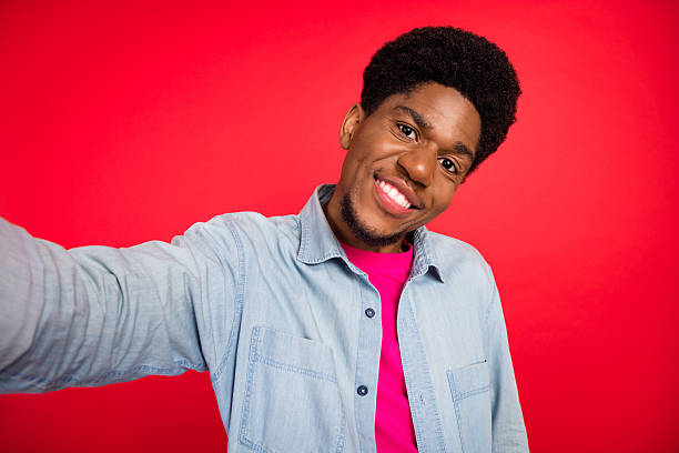 istock Portrait of attractive cheerful curious brunet guy thinking copy empty space isolated over bright red color background 2253914801