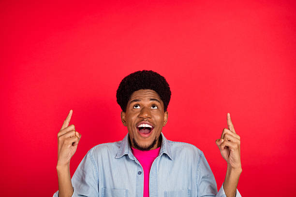 istock Portrait of attractive cheerful curious brunet guy thinking copy empty space isolated over bright red color background 2253914823