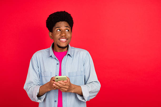 istock Portrait of attractive cheerful curious brunet guy thinking copy empty space isolated over bright red color background 2253914901