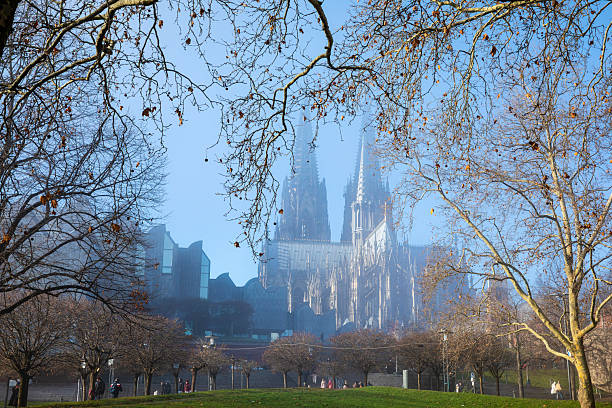 View of Cologne Cathedral in the morning mist, seen from the Rhine promenade