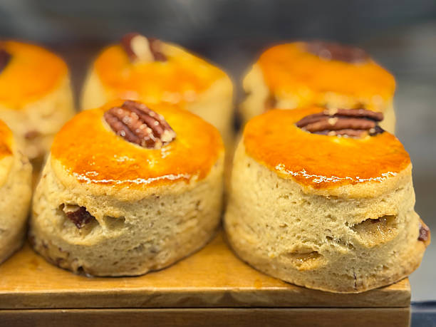 Image of fruit, raisins, and pecans plain scones biscuits, freshly baked bakery treats, golden eggwashed pastries