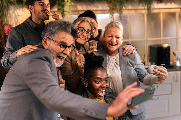 istock Business colleagues taking a selfie together during break in office kitchen 2253923844