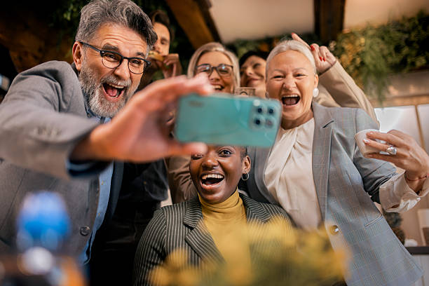 istock Business colleagues taking a selfie together during break in office kitchen 2253923891