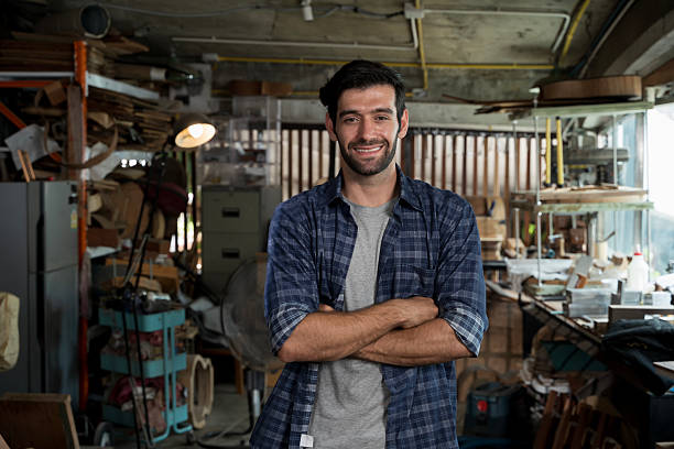 istock Smiling luthier standing in workshop, confident craftsman in woodworking studio portrait 2253924704