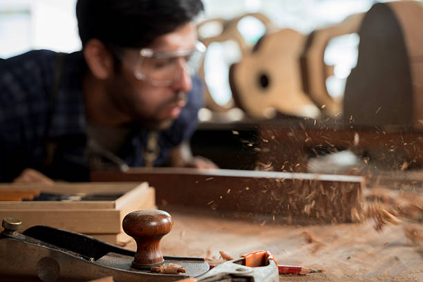 istock Woodworking Hand Plane with Flying Wood Shavings, Carpenter Blowing Dust in Workshop 2253925076