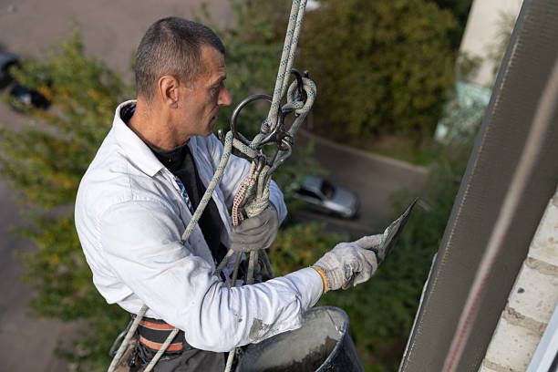 istock Construction worker insulates the facade of a house at height. 2253934006