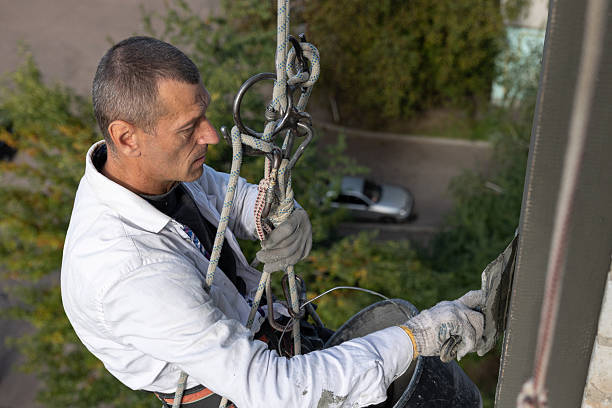 istock Construction worker insulates the facade of a house at height. 2253934007