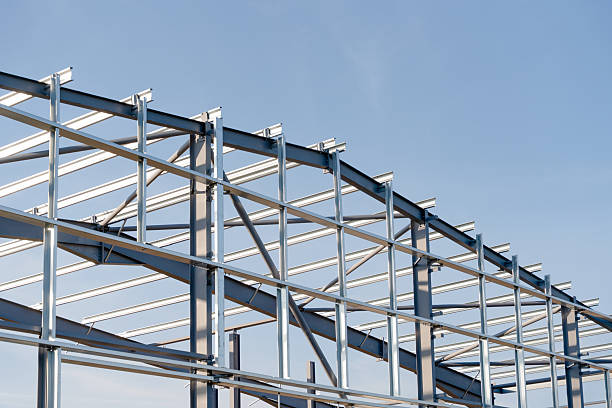 istock Steel frame building structure stands against blue sky 2253934811