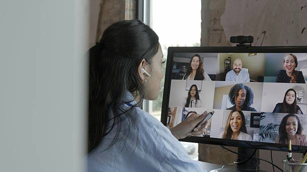 istock Diverse group of professionals collaborating remotely through a video conference call on a computer screen. 2253936540