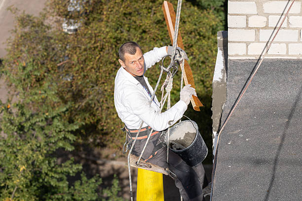istock Construction worker insulates the facade of a house at height. 2253938322