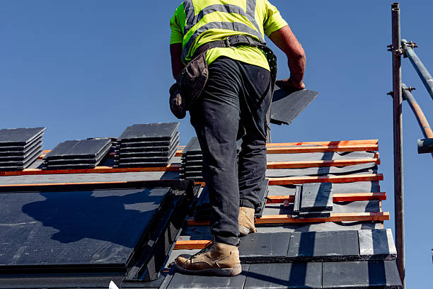 istock Roofer installing roof tiles using nails and hammer 2253938728