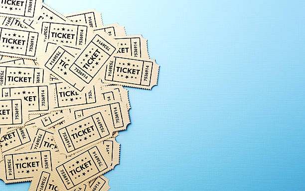 istock Scattered Beige cinema tickets on a blue background, with motion effects. 2253938887