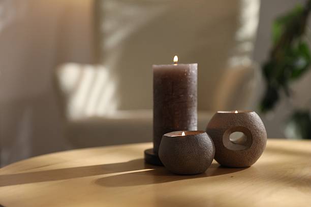 istock Burning candles on wooden table indoors, closeup with space for text 2253939401