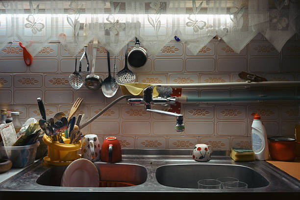 Lifestyle details, old double sink with dishes in home kitchen.