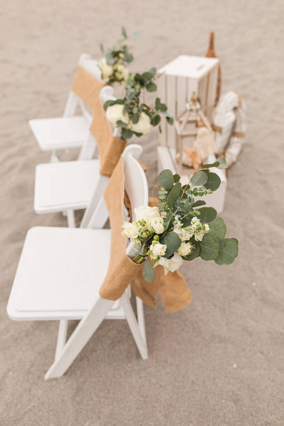 istock Soft Pastel Beach Wedding Decor with Burlap, Rustic White Wood, Rattan, Ivory-Colored Roses, Cream Stock Spray Flowers & Sage-Green Eucalyptus for a Modern Rustic Beach Wedding in Jupiter, Florida in December 2025 2253946159