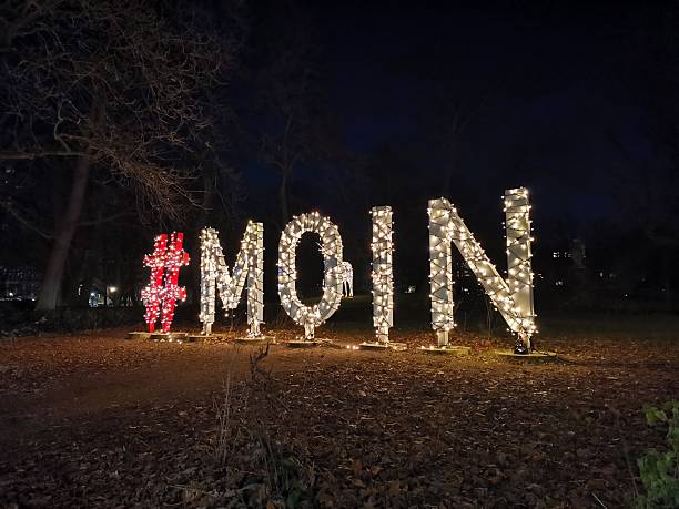 istock Word #Moin illuminated in a public square with grass in the darkness 2253947550