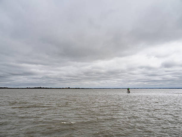 Choppy gray water of the Delaware River under a dramatic cloudy sky