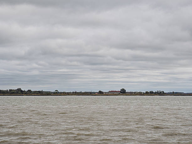 Wide view of the Delaware River with distant shoreline structures