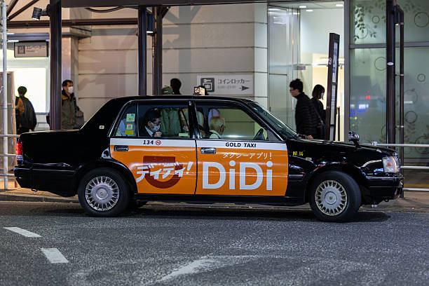 Tokyo, Japan - December 4, 2025 : A taxi with a sticker of Chinese Taxi Apps Didi in Tokyo, Japan.