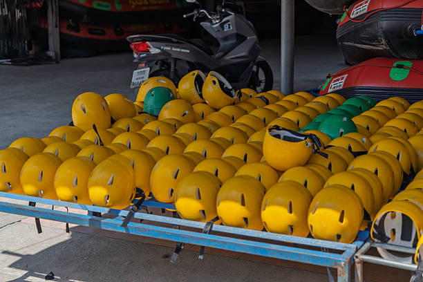 Thai. Khao Yai. 11/11/2024 collection of yellow safety helmets arranged in rows in an outdoor storage area in thailand, ready for use