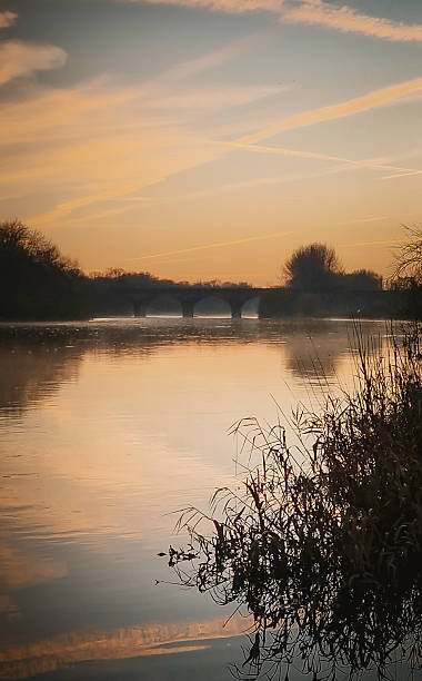 istock Misty river landscape with stone bridge at sunrise 2253952731