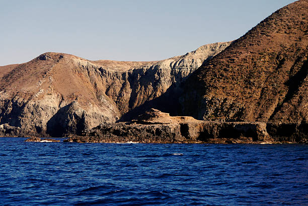 The barren, hulking cliffs of Santa Cruz Island looms large from the relative ease of a sight-seeing boat. Channel Islands National Park, California 2014