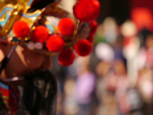 The Chinese New Year is marked with a dancing parade: dressed as a lion or a dragon, bystanders make offerings into it's mouth for a prosperous New Year.  California, 2013