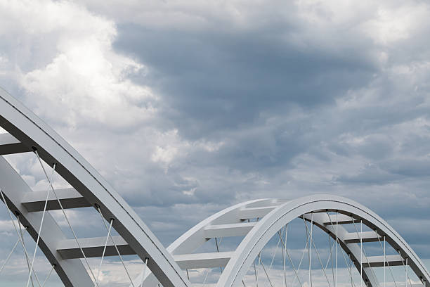 istock Abstract bridge arch against cloudy sky 2253956198